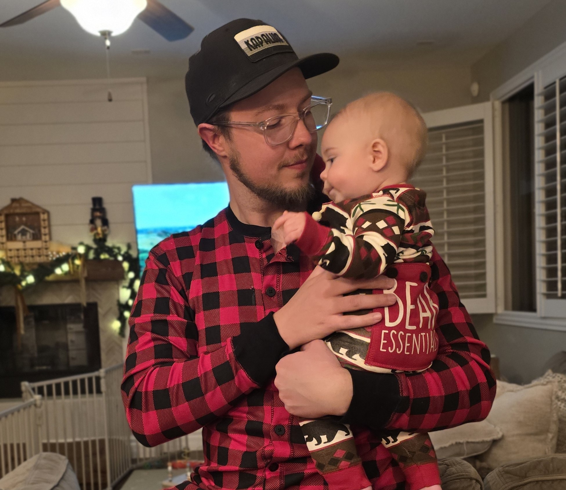 Nick holding his baby son at Christmas